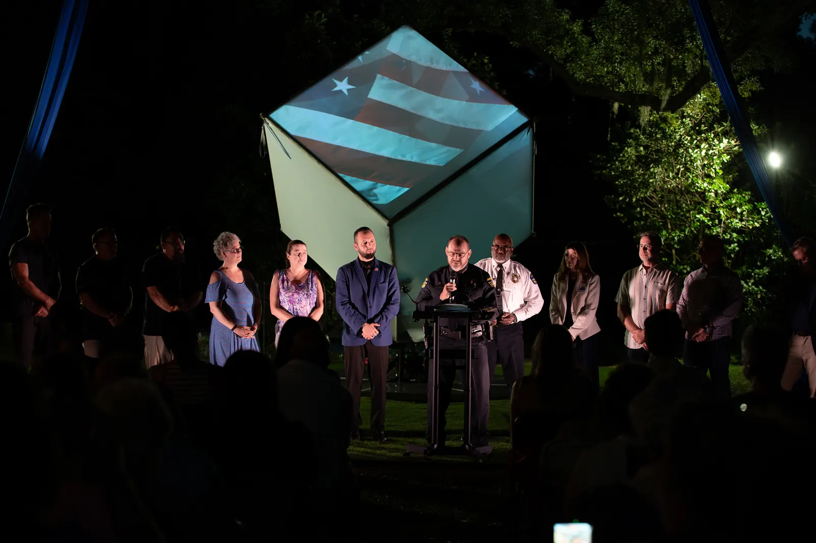 A wide view captures the full group beneath blue aerial rigging.