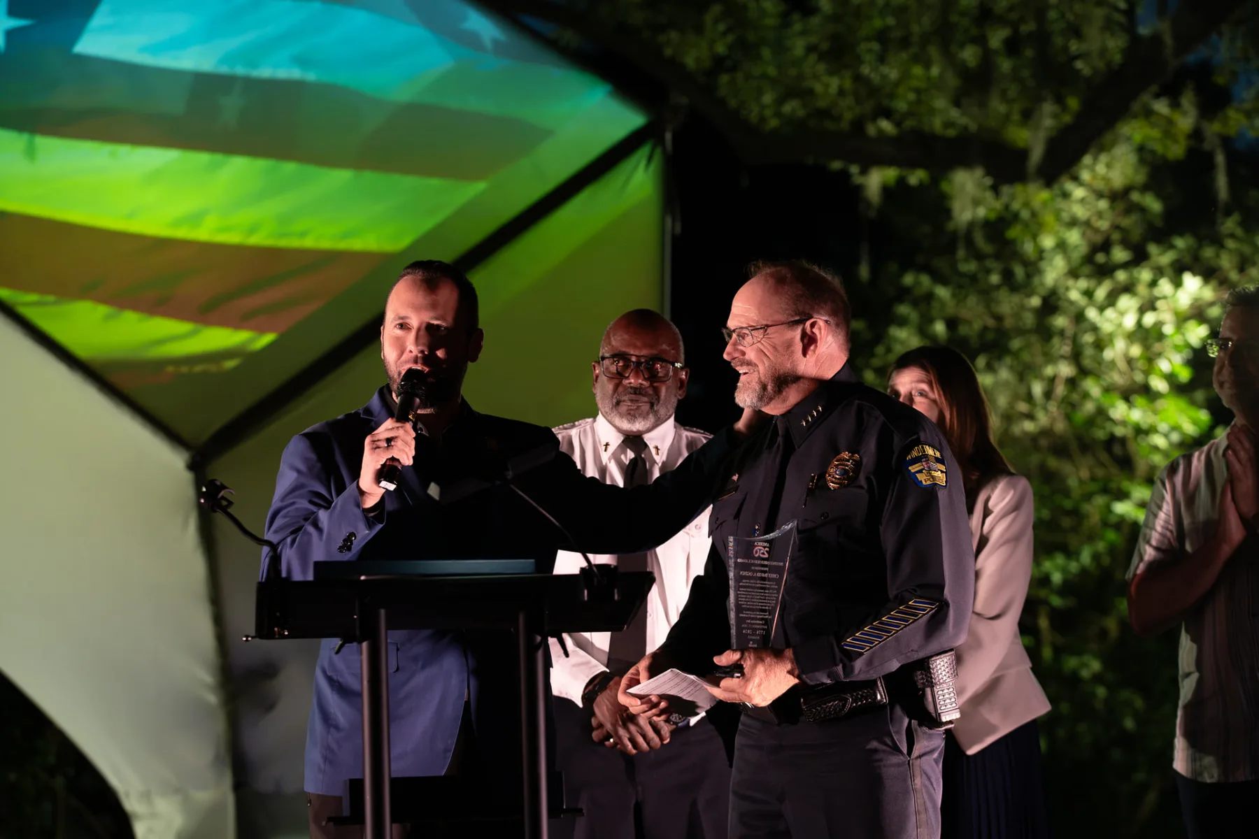 Austin Arthur, Event Chair, speaks beside Chief David Ogden during the recognition ceremony.