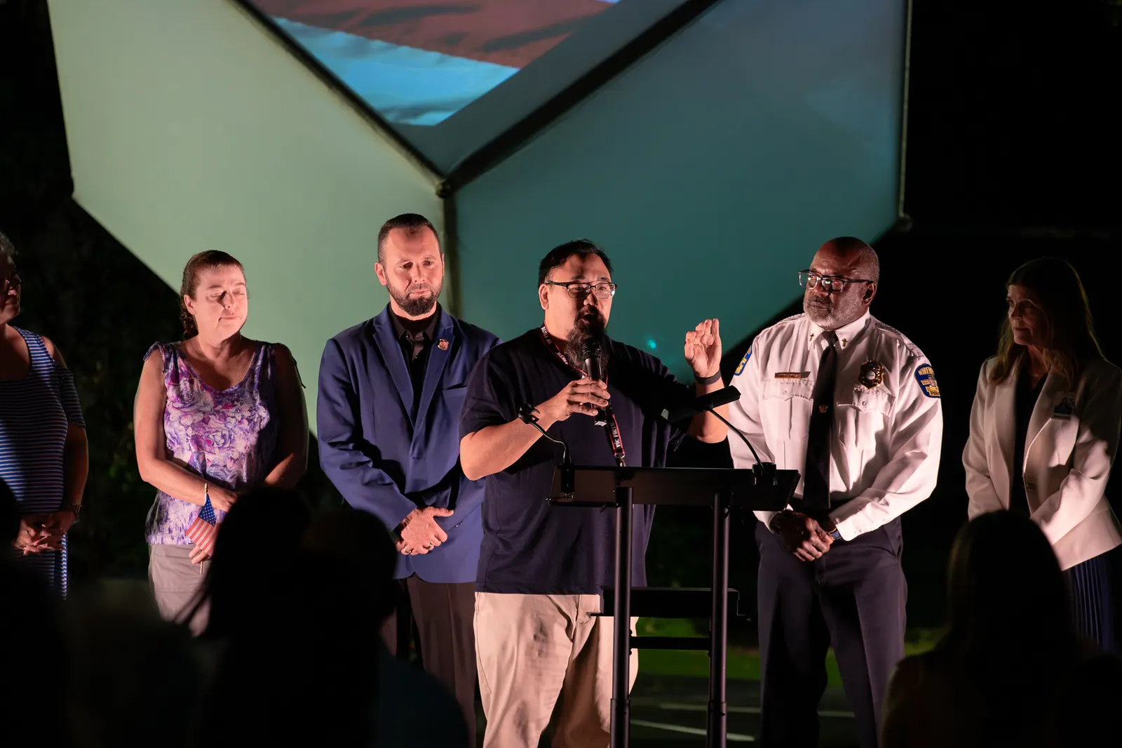 A line of civic and community partners assembles across the stage.